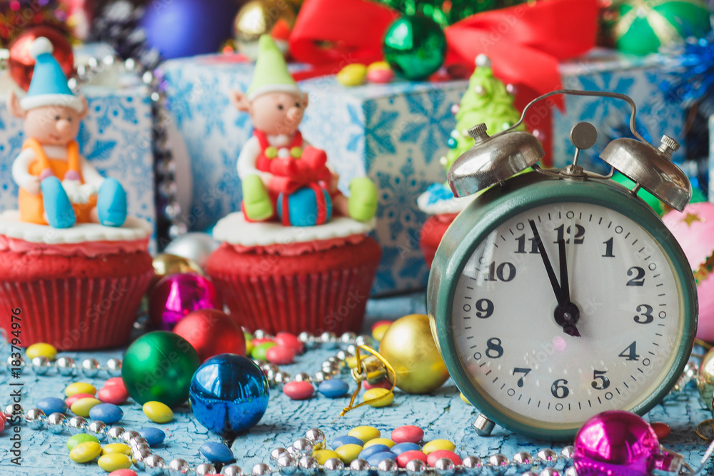 Christmas clock and cupcakes with colored decorations
