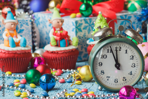 Christmas clock and cupcakes with colored decorations © lisssbetha