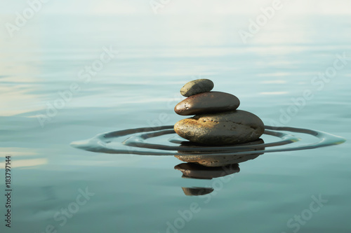 Photography Stack of round smooth stones on a seashore