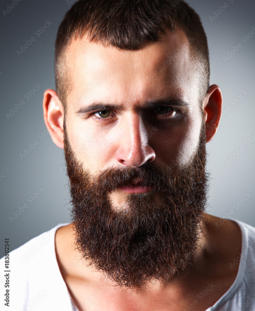 Portrait of handsome man standing, isolated on grey background Portrait of handsome man standing, isolated on grey background