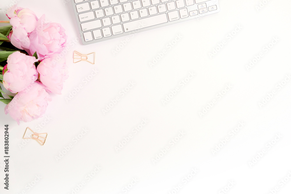 Feminine desk scene - flatlay with peonies and keyboard Feminine desk scene - flatlay with peonies and keyboard