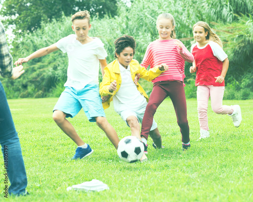 children are jogning and playing football