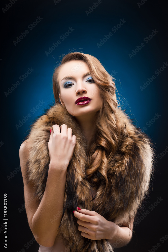 Portrait of beautiful elegant girl wearing a fur raccoon collar. Portrait of beautiful elegant girl wearing a fur raccoon collar.