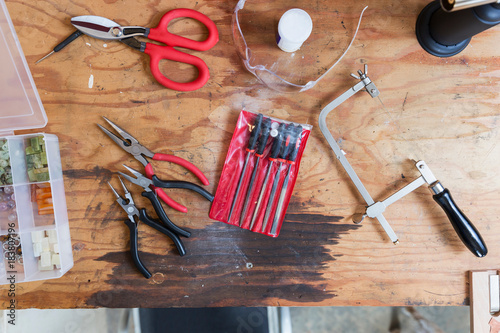 Jewellery makers tools on workbench, overhead view