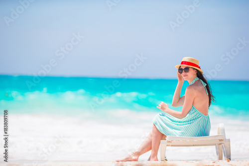 Young woman on a tropical beach with hat