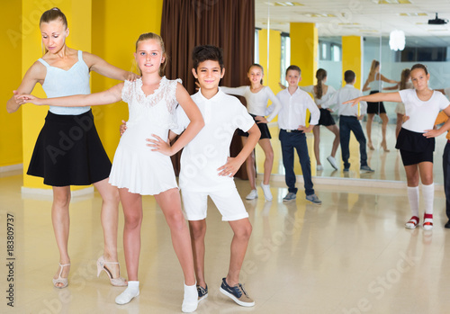 Teacher is demonstrating to kids how to dance the twist