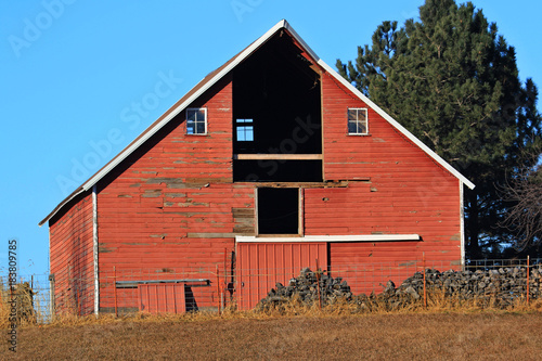 Red Barn with early morning sun peaking thru into the hay loft