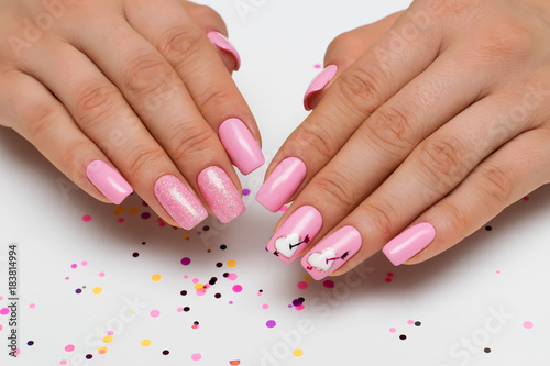 gently pink manicure with sparkles with painted hearts and arrows on square long nails    