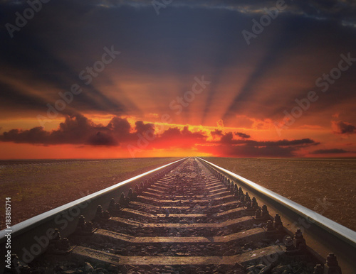 red sunset with rails going away