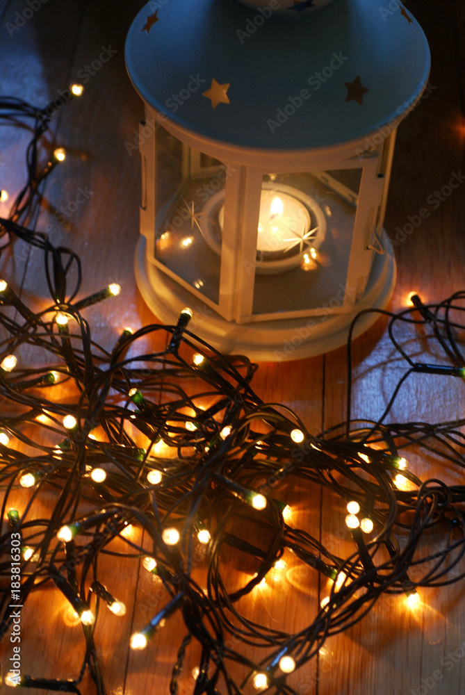 Set of white lantern with christmas lights and candy canes on the wooden floor. Set of white lantern with christmas lights and candy canes on the wooden floor.