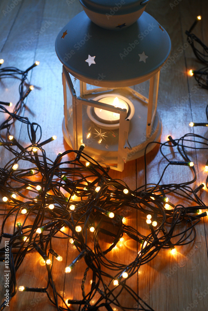 Set of white lantern with christmas lights and candy canes on the wooden floor.