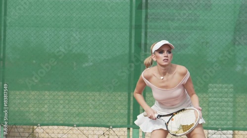 Sexy tennis girl posing at the camera photo