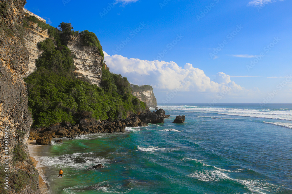 Scenic landscape of high cliff with fantastic blue sky at Uluwatu cliff. Travel Bali, Indonesia