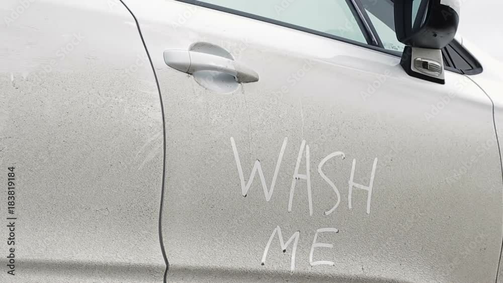 Dirty white car in need of washing
