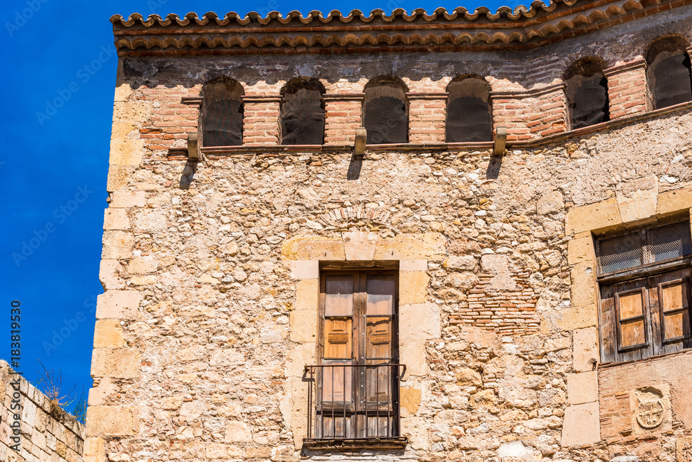 View of an old building on a blue background, Tarragona, Catalunya, Spain.