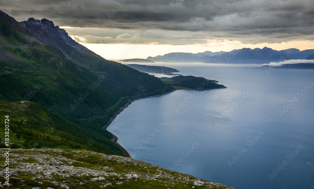 Dramatic scenery of the mountains and the sea with the cloudy sky in Troms, Northern Norway, Scandinavia, Europe