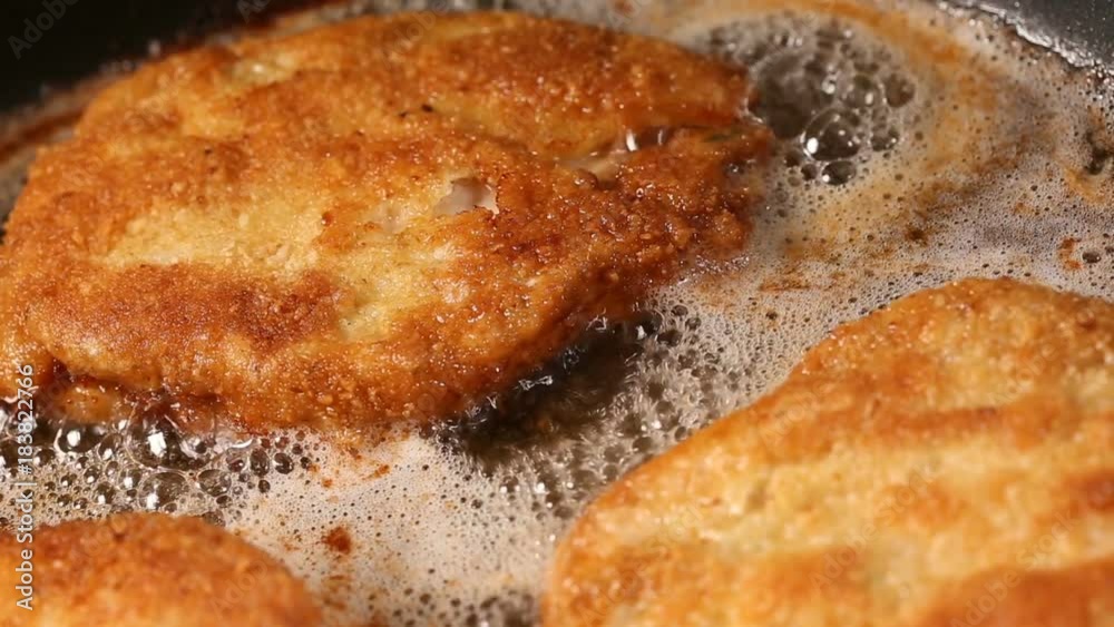 Frying pork meat coated with breadcrumbs in a pan Frying pork meat coated with breadcrumbs in a pan