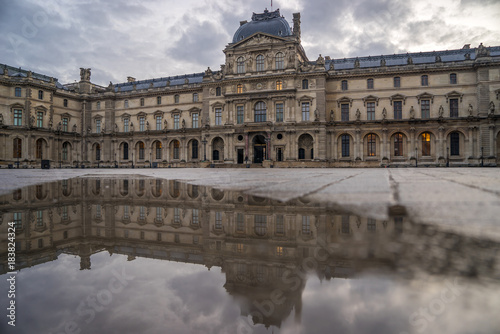 iew of famous Louvre Museum with Louvre Pyramid at evening