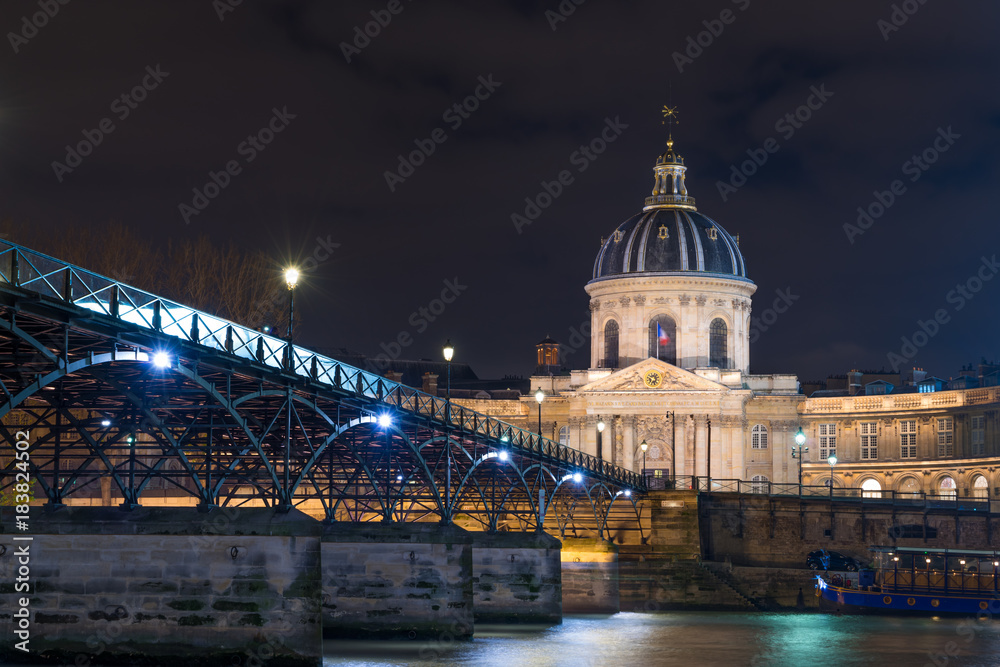 River Seine with Pont des Arts and Institut de France at night in Paris