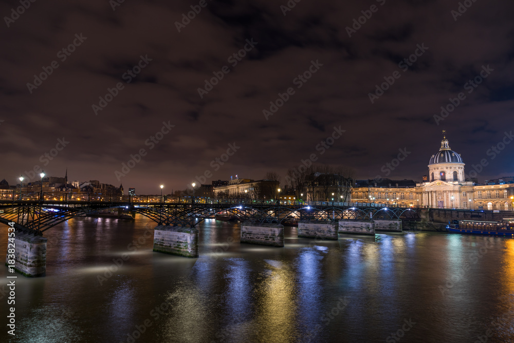 River Seine with Pont des Arts and Institut de France at night in Paris