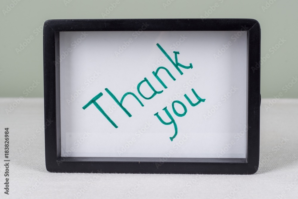 Text word THANK YOU, in black frame, on white table. Text word THANK YOU, in black frame, on white table.