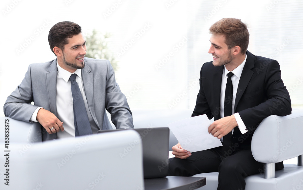 employees talking, sitting the lobby of the office employees talking, sitting the lobby of the office