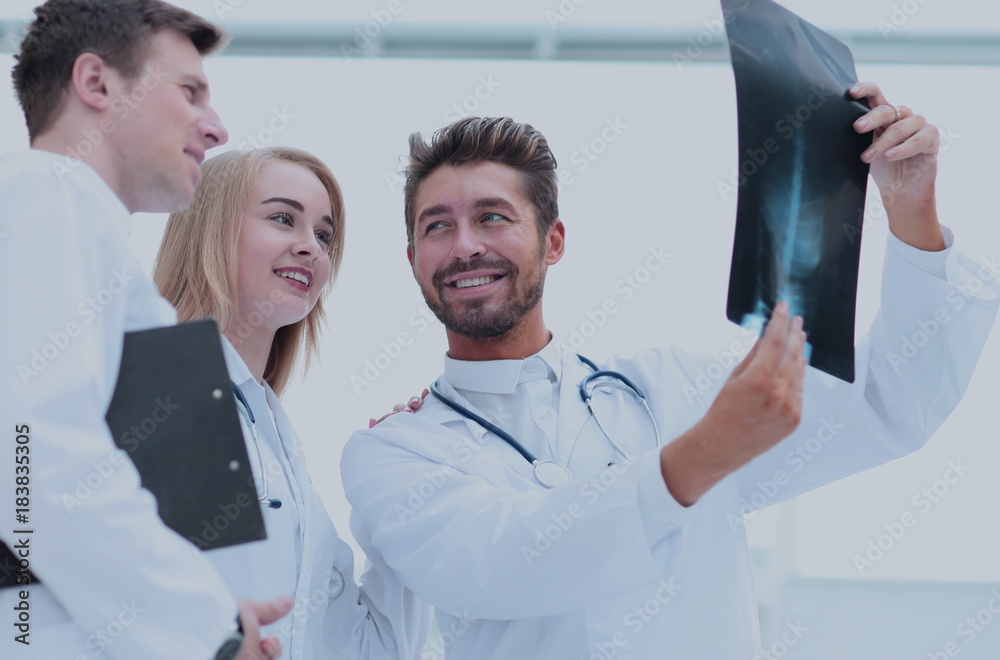 Handsome bearded doctor smiling confidently while discussing wit Handsome bearded doctor smiling confidently while discussing wit
