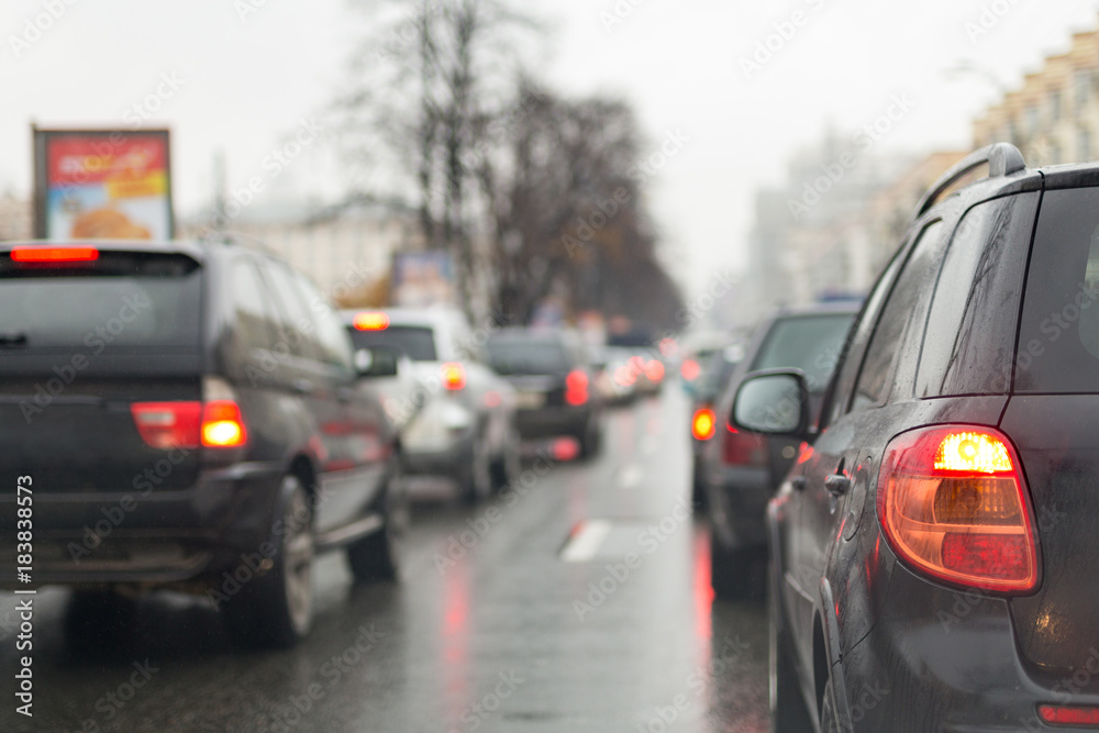 Traffic jam on a city street  on wet  road after rain