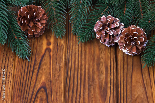 Christmas decoration cones fir on brown wooden background.