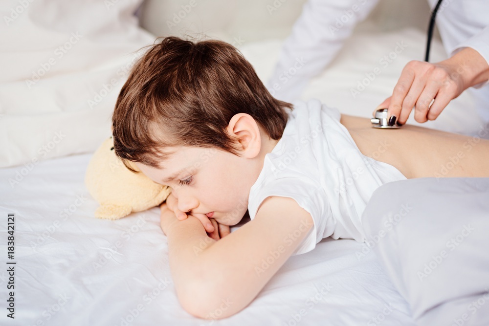 Doctor examines child with stethoscope Doctor examines child with stethoscope
