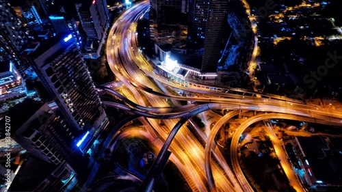 Aerial photography of urban city highway with traffic's light trail at night.