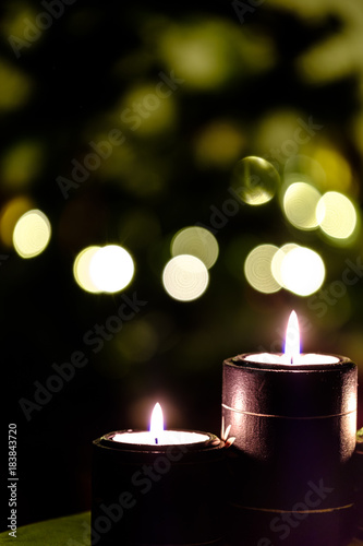 Two candles with Background Christmas Tree Lights