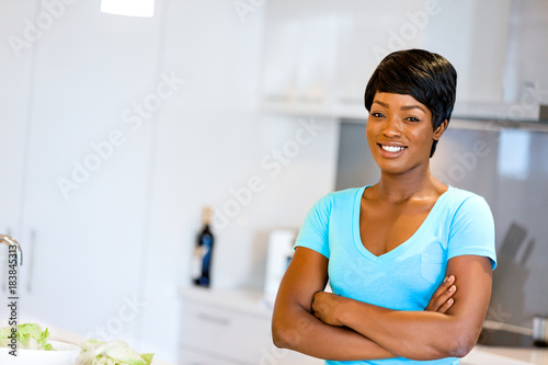 Beautiful woman standing in the kitchen and smiling