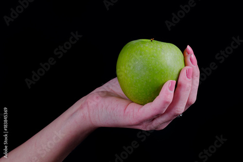 Green apple in girl hand
