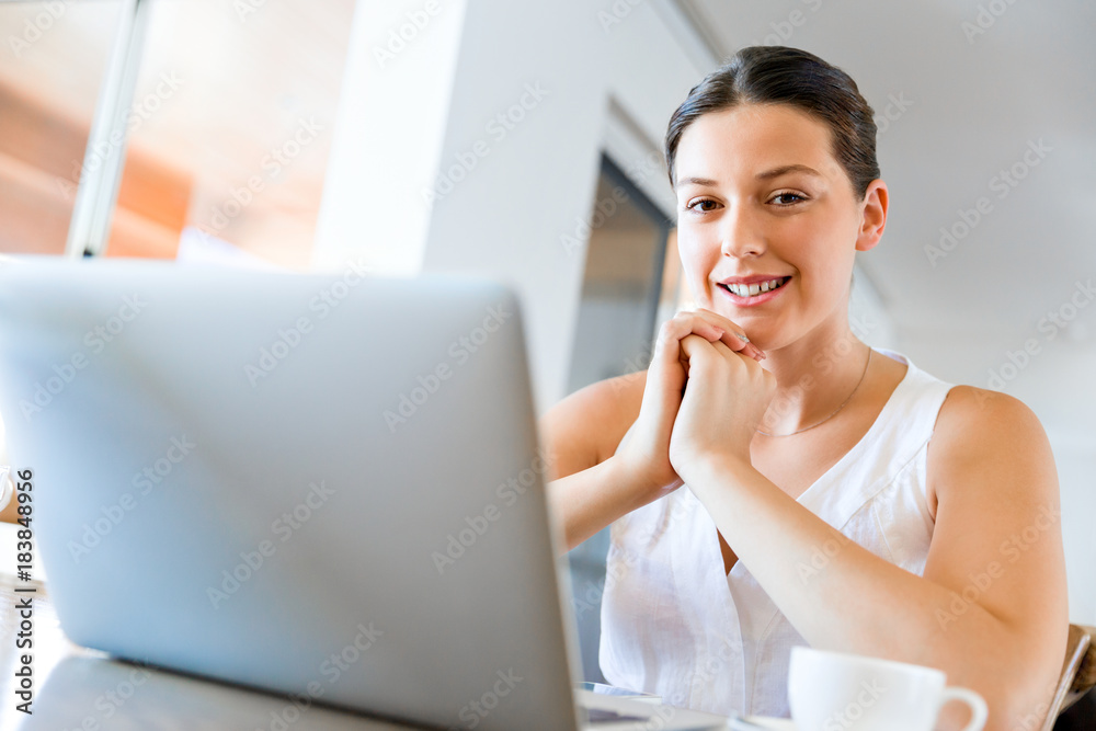 Young beautiful woman working on her laptop Young beautiful woman working on her laptop