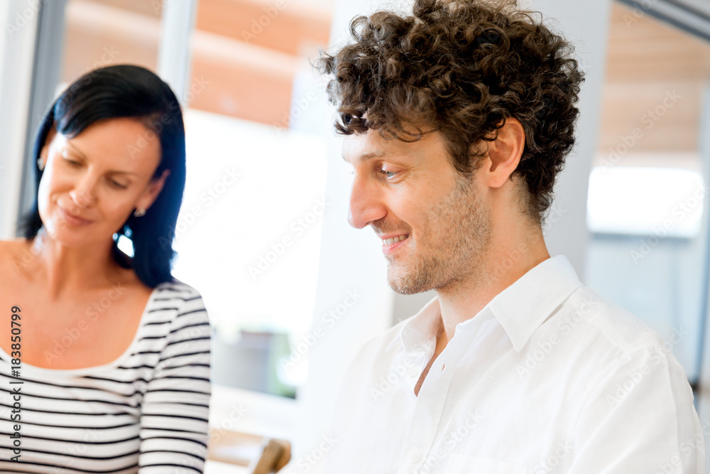 Happy modern couple working on laptop at home Happy modern couple working on laptop at home