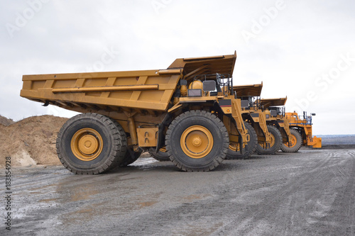 Four large quarry trucks removed from the side © photopetrovichs