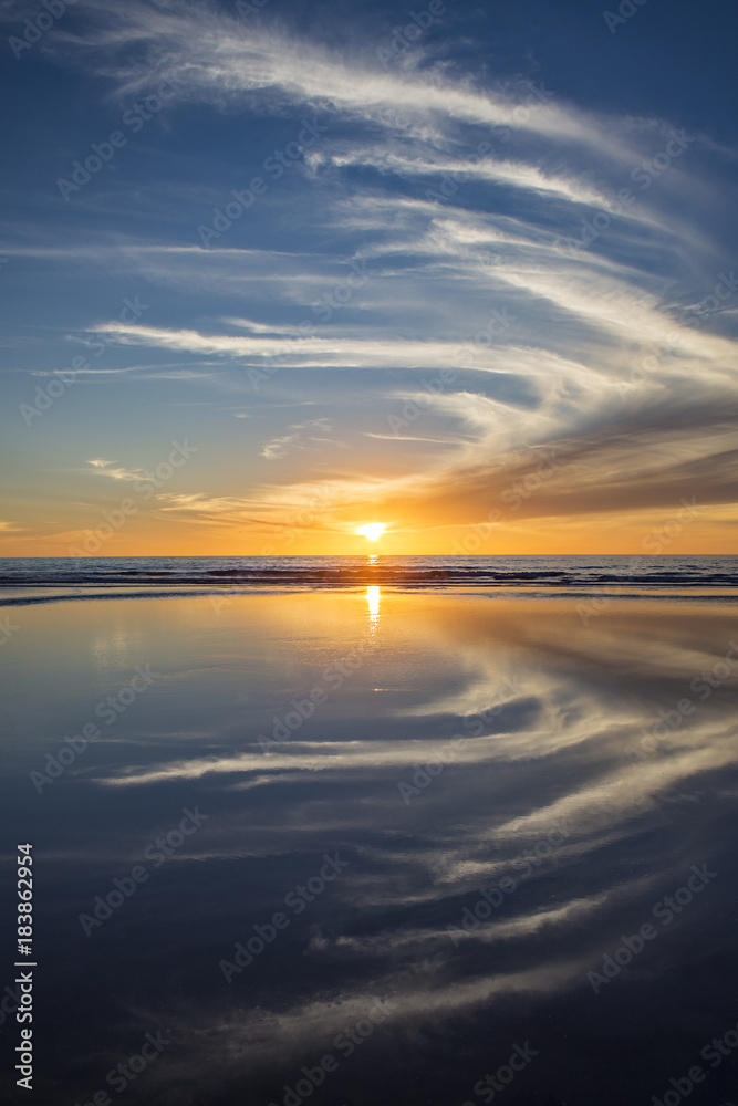 Sun setting at beach at low tide in San Diego, California