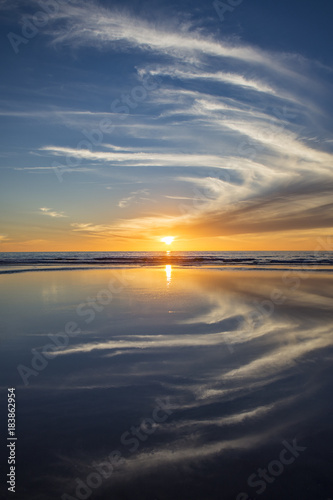 Sun setting at beach at low tide in San Diego, California