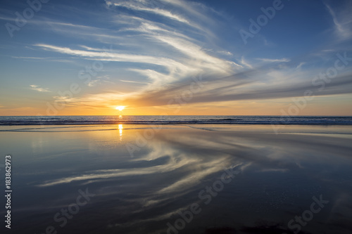 Sun setting at beach at low tide in San Diego, California © Justin