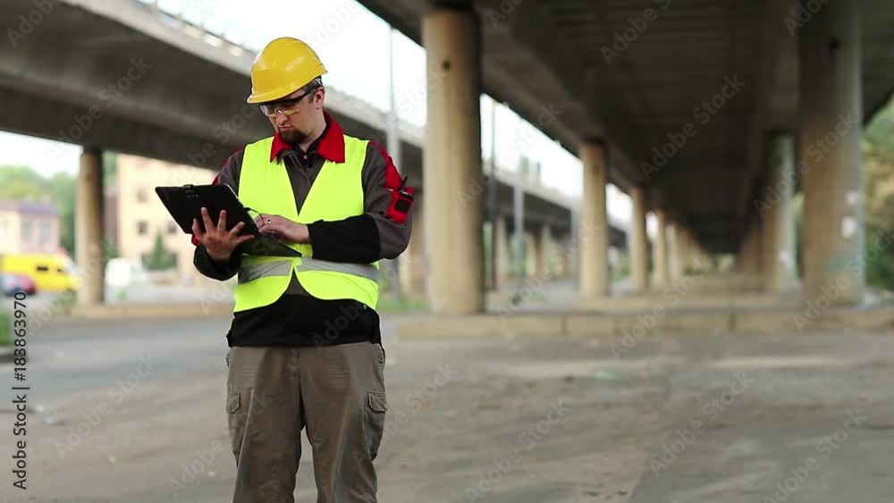 Workman Computer Workman with personal computer under overpass. Manager of the repair ...