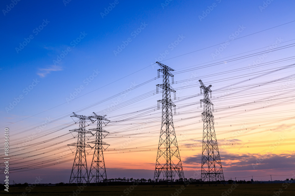 High voltage power tower landscape at sunset