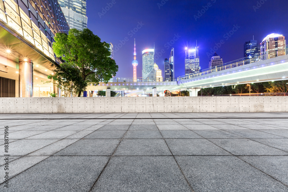 Naklejka premium Empty square floor and modern cityscape at night in Shanghai,China