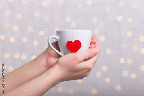 cup with tea bag heart in hand