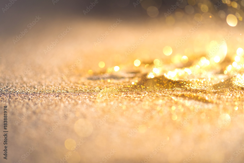 Sprinkle glitter gold dust in the dark textured abstract background elegant for Merry christmas and Happy new year