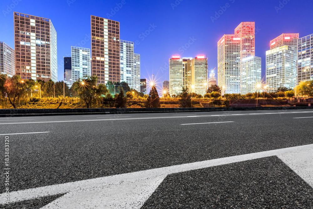 Asphalt highway and modern business district office buildings in Beijing at night,China