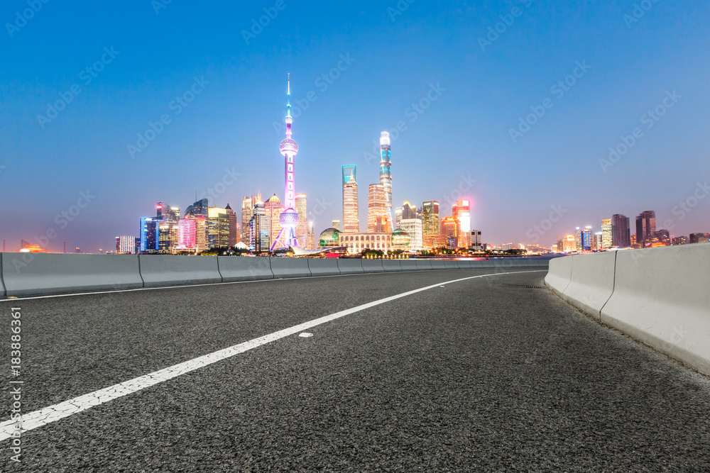 Asphalt road and modern city famous architectural scenery in Shanghai at night,China