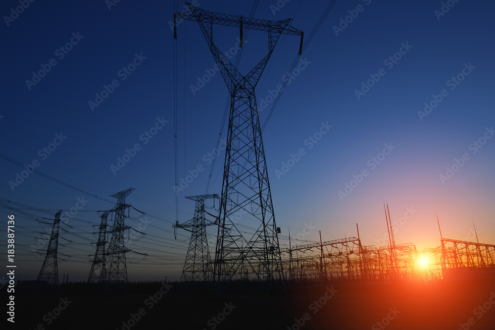 Fototapeta premium The silhouette of the evening electricity transmission pylon