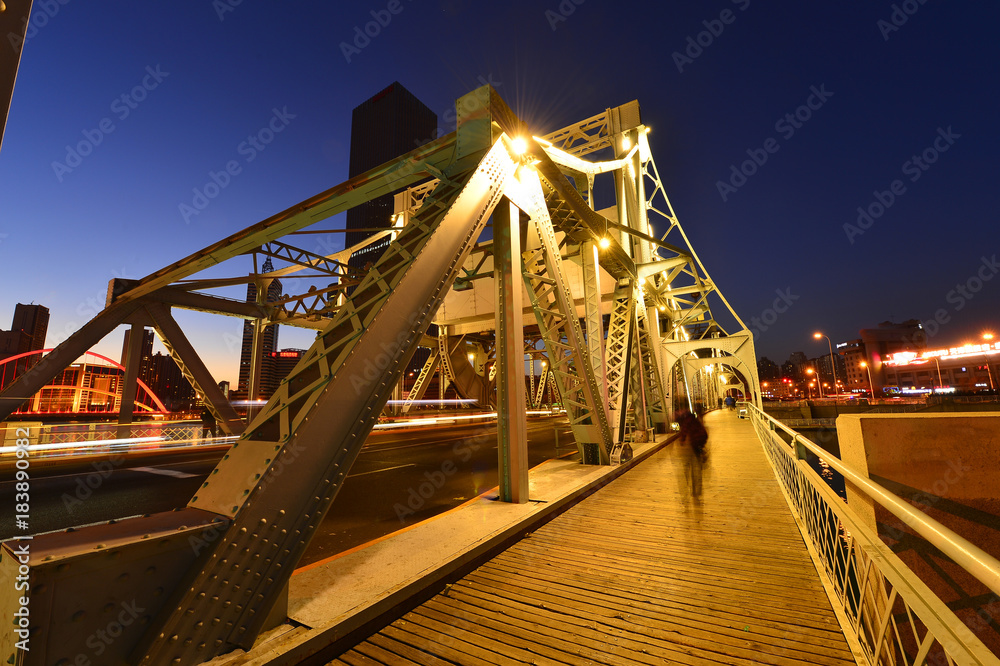 Fototapeta premium The modern city highway Bridges night landscape car light trails arc in tianjin