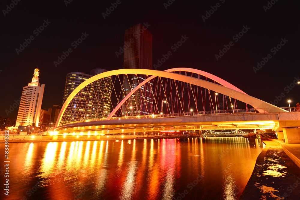 The modern city highway Bridges night landscape car light trails arc in tianjin